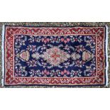 A Persian blue ground Kerman rug