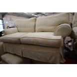 A large cream Multiyork sofa and footstool