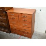 A modern teak finish chest of drawers