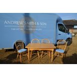 A modern beech extending dining table to/w four spindle back chairs