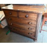 A large Victorian mahogany chest of two short over three long graduating drawers with turned