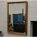 A rectangular wall mirror in decorative gilt frame