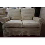 A Multiyork two seater scroll arm sofa with loose, patterned cream covers