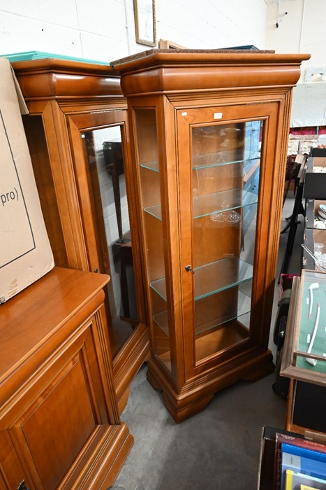 A pair of teak glazed display cabinets