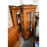 A pair of teak glazed display cabinets