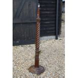 A turned and carved mahogany standard lamp