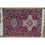 A Caucasian purple ground rug