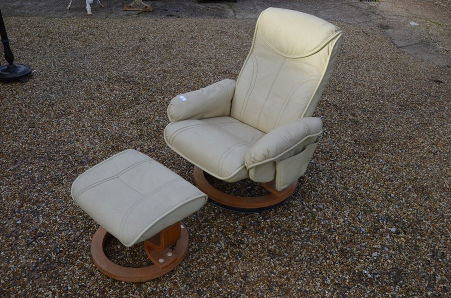 A cream leatherette Stressless style reclining armchair and stool (2)