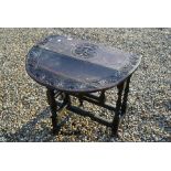 An early 20th century carved oak drop leaf table