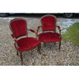 A pair of French carved giltwood open armchairs