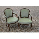 A pair of French carved oak open armchairs