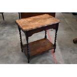 An early 20th century oak two-tier lamp table