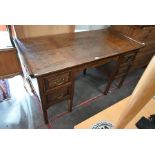 A panelled oak kneehole desk with five drawers