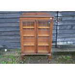 An oak display cabinet with lead glazed doors