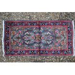 A Persian blue ground Kerman rug