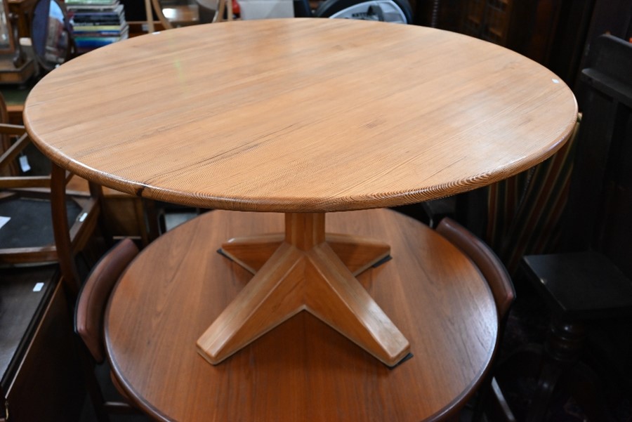 A bespoke circular pitch-pine dining table