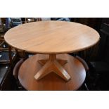 A bespoke circular pitch-pine dining table