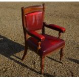 An Edwardian mahogany library armchair