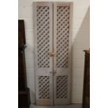 A pair of tall narrow lime-washed pine doors