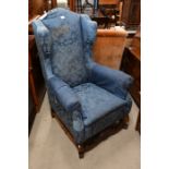 A 19th century oak framed wingback armchair