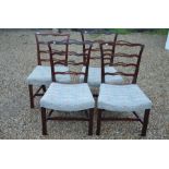 A set of four Georgian mahogany wavy ladderback dining chairs