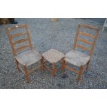 A pair of provincial pine rush seated ladder back chairs to/w a rush-woven stool