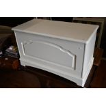 A modern cream painted pine blanket chest
