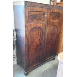 A 19th century flame mahogany hall cupboard