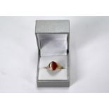 A 9ct yellow gold signet ring inset with oval chalcedony