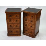 A pair of Victorian leather top burr walnut four drawer cabinets