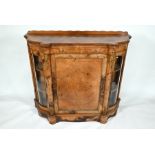 A Victorian gilt-metal mounted walnut cabinet of serpentine form