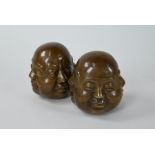 A pair of Oriental filled bronze four-faced Buddha heads