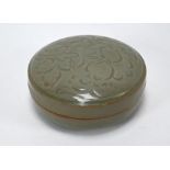 A Chinese celadon-glazed circular box and cover, 13 cm diam