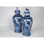 A pair of 19th century Chinese blue and white vases and covers with four character Kangxi mark