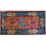 An old Chinese rug, brown/red ground with floral symbols