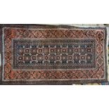 An old Belouch rug, brown and orange