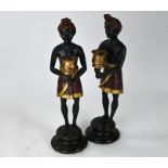 A pair of cold-painted bronze figural candlesticks
