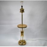 An Arts & Crafts style brass standard lamp with integral wine table