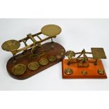 Two sets of brass postage scales with weights