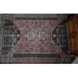 A large Persian carpet, geometric designs, washed faded pallette, 285 cm x 204 cm