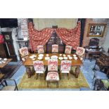 A substantial solid oak refectory style dining table and set of eight dining chairs