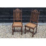 A pair of early 20th century carved oak cane seated side chairs