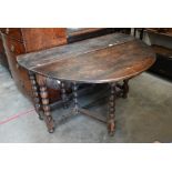 An 18th century and later elm and oak drop leaf dining table
