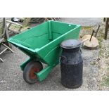 A vintage green painted wooden wheelbarrow and milk churn (2)