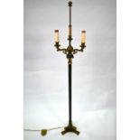 An Empire style brass three branch standard lamp