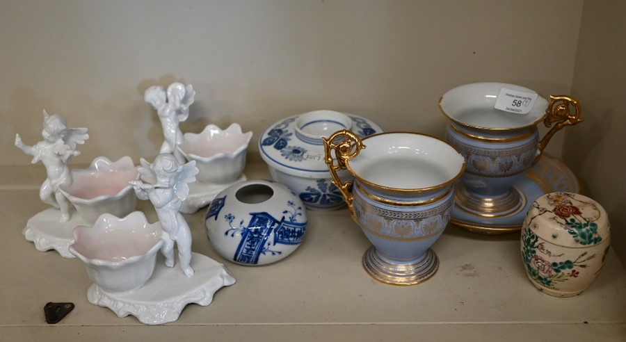 A pair of Sevres porcelain lilac-ground and gilt cups and a saucer