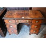 A 19th century crossbanded walnut kneehole desk