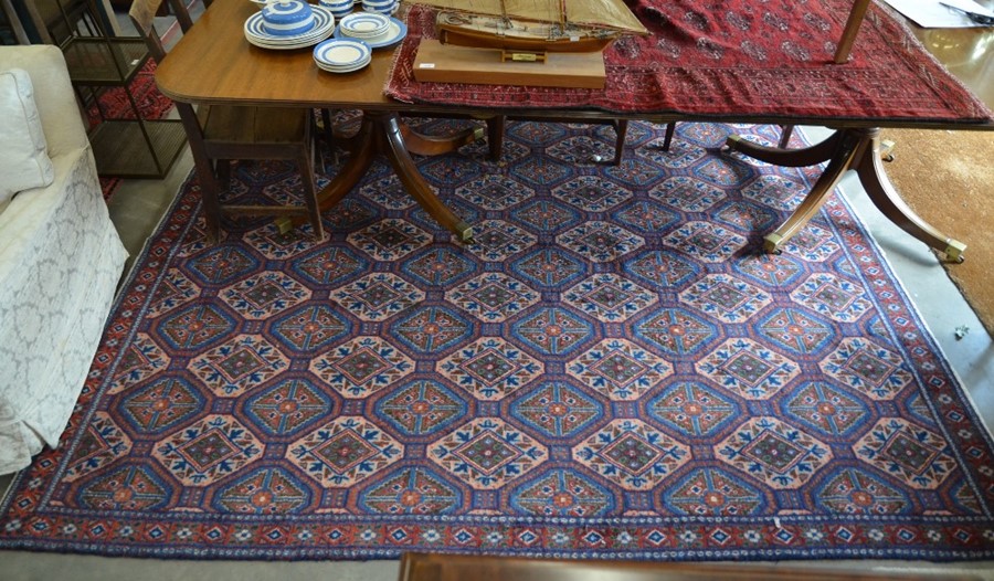 A Persian Sirjan carpet, repeating mid-blue and ivory lozenge design