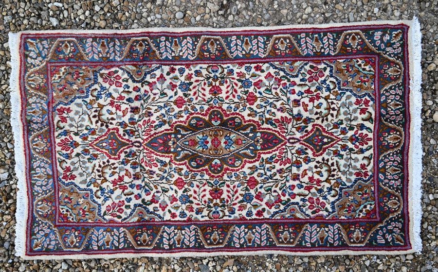 A Persian cream ground Kerman rug