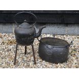 Cast iron kettle on stand and cauldron